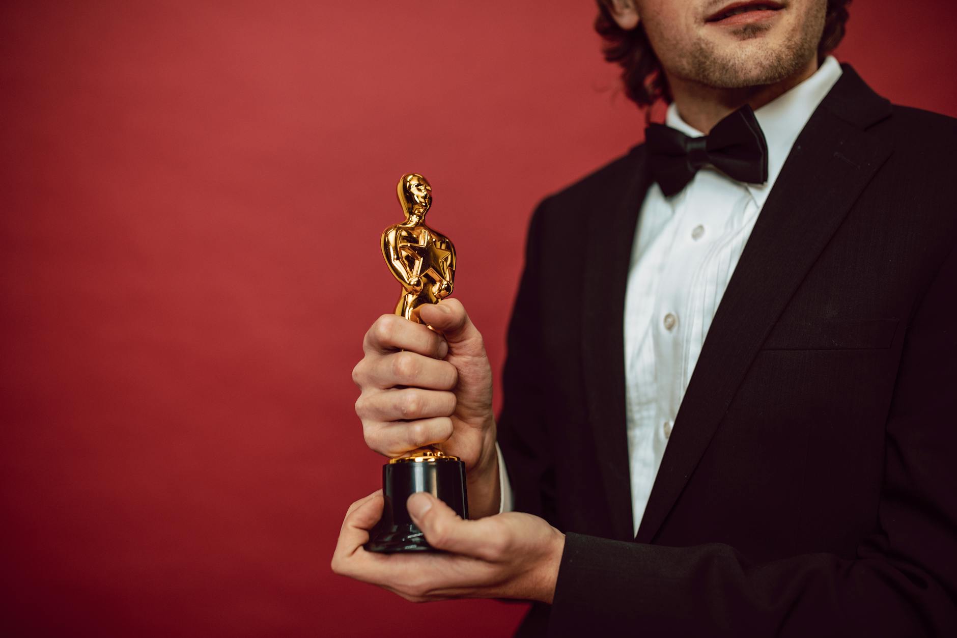 an actor holding his award