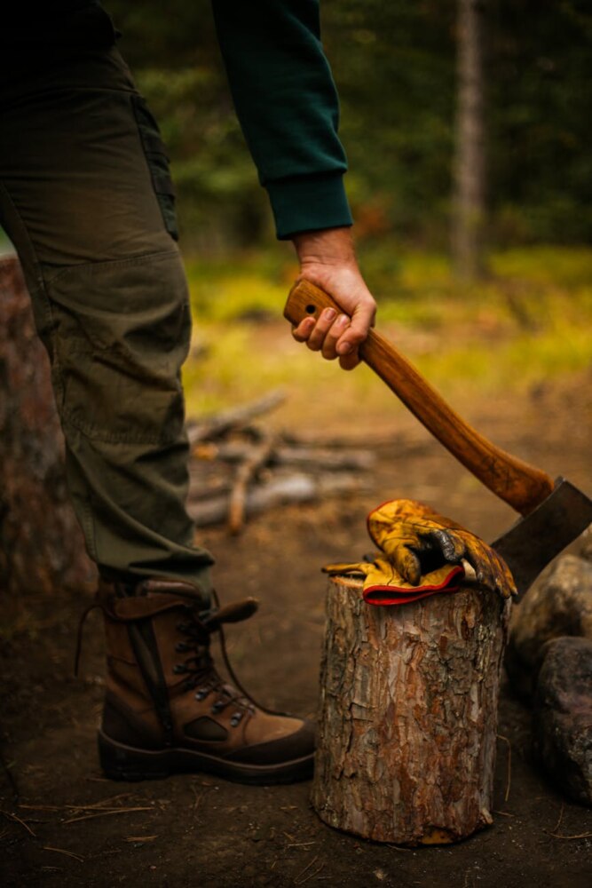 a person s hand holding an axe
