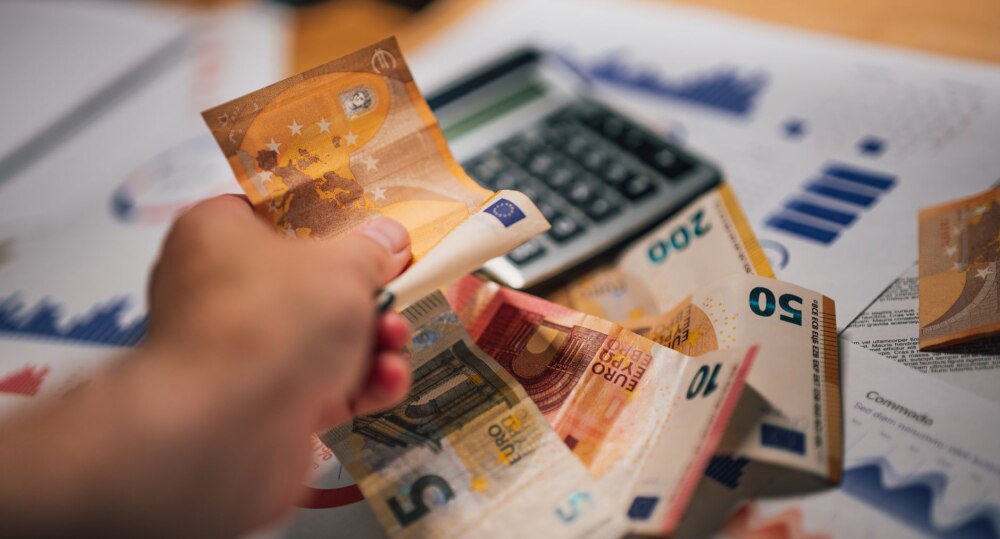 euro banknotes with financial documents and calculator