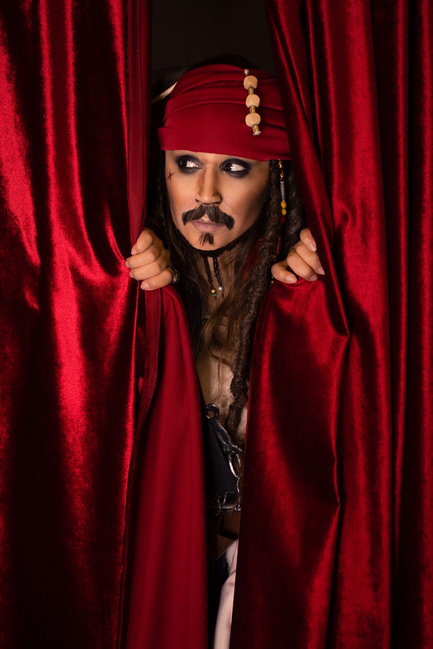 jack sparrow behind red curtains
