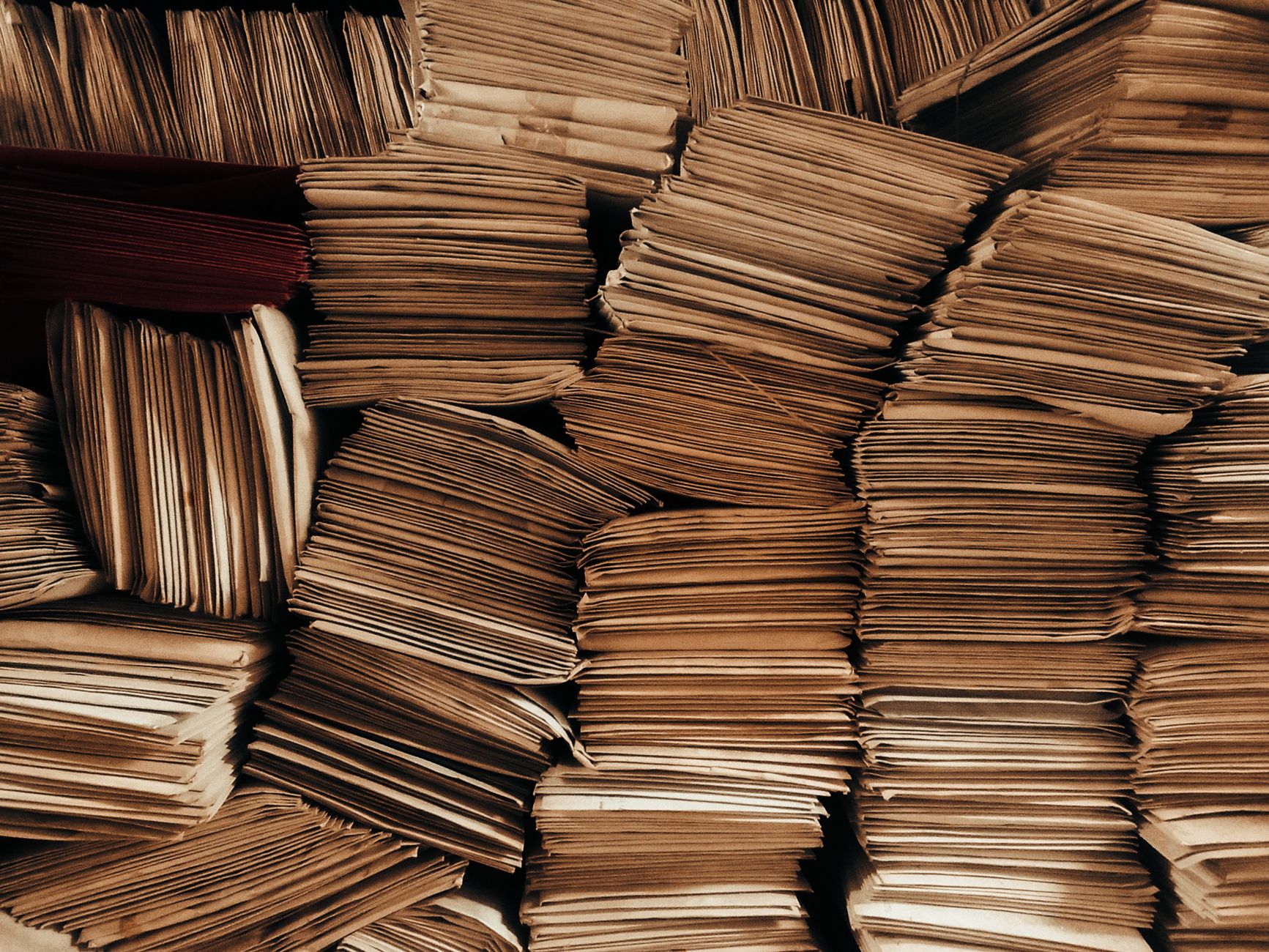 stacked brown envelopes in organized rows